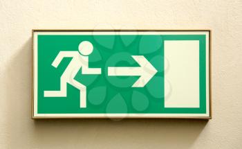 Emergency exit sign on a wall - closeup