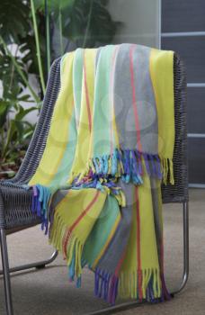 Colourful throw draped over a chair
