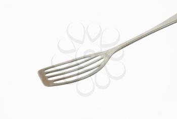 Metal spatula with perforated blade that allows liquids to drain through