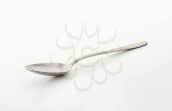 Tarnished metal spoon with deep cup