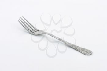 Old dinner fork decorated on the handle