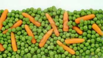 Closeup View of Green Peas and Baby Carrots
