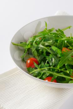 bowl of fresh rocket leaves with cherry tomatoes