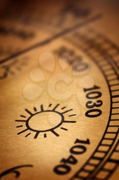 Symbol of sunny weather on an old barometer

