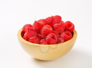 Fresh raspberries in a wooden bowl