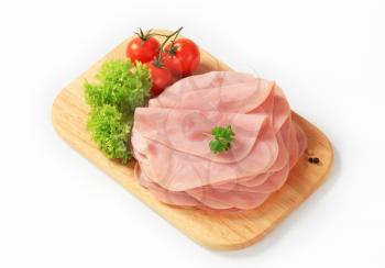 Thinly sliced ham on a cutting board
