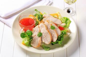 Sliced chicken breast fillet with salad and sweet chilli sauce
