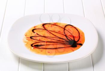 Hot sauce and balsamic vinegar on plate