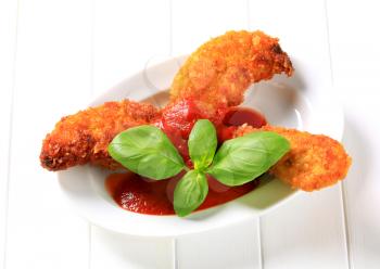 Crispy chicken tenders with tomato dipping sauce 