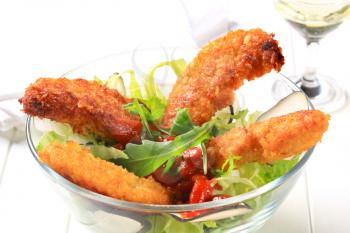 Crispy chicken tenders with tomato dipping sauce and lettuce