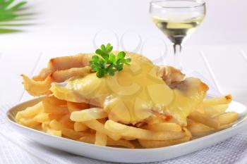 Cheese topped fish fillets served with French fries