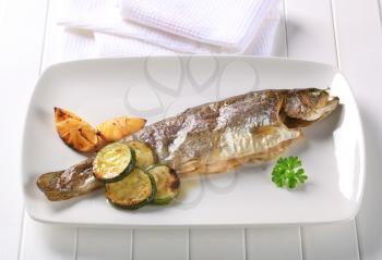 Oven baked trout with lemon and courgette
