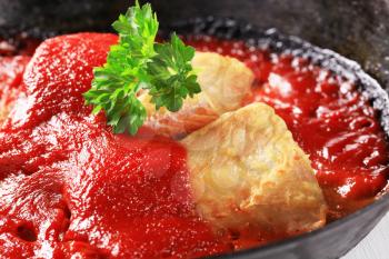 Pan fried fish fillets in rich tomato sauce