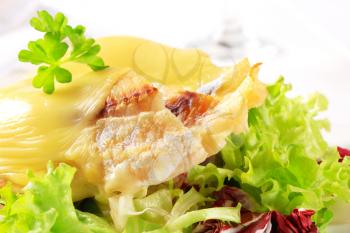 Cheese topped fish fillets served with salad