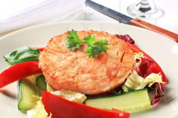 Pan fried salmon served with vegetable salad