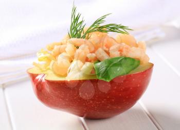 Half apple topped with shrimps