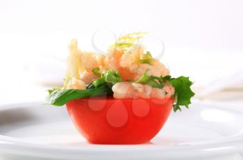 Half tomato topped with shrimps