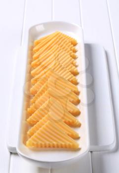 Semi-hard cheese cut into triangles 