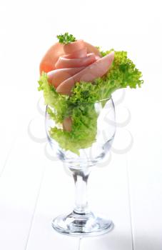 Ham rose and curly lettuce in a glass