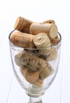 Cork bottle stoppers in a wine glass