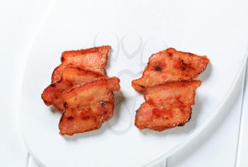 Pan roasted pieces of salt pork on cutting board