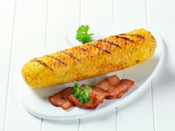 Grilled corn and fried pieces of salt pork