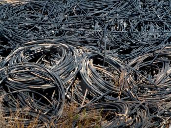 Piles of waste cables at junkyard