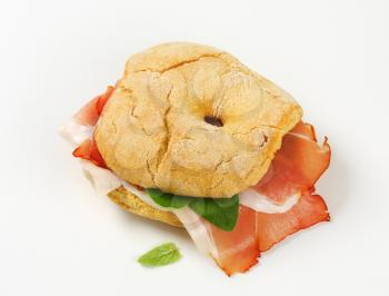 Ring-shaped bread roll (friselle) with slices of Schwarzwald ham