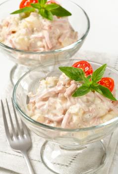 Ham and potato salad in glass serving bowls