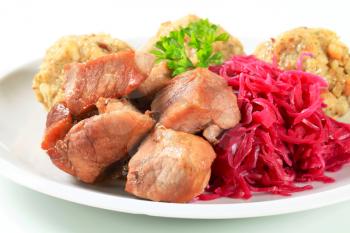 Dish of roast pork with Tyrolean dumplings and red cabbage