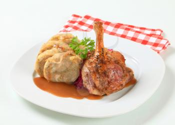 Dish of roast duck leg with bread dumplings and red cabbage