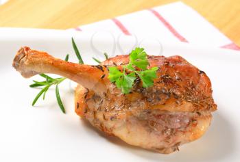 Roast duck leg topped with caraway seeds