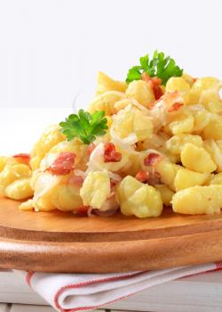 Small potato dumplings with bacon and white cabbage