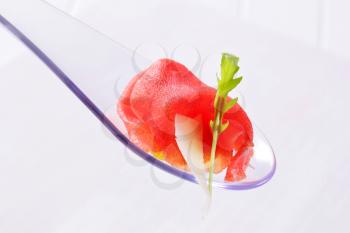Thin slice of raw beef on spoon