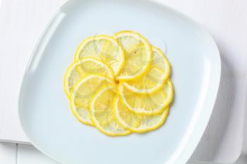 Thinly sliced lemon on plate