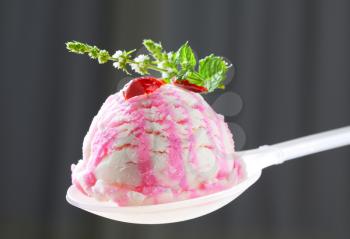 Scoop of berry ice cream on spoon