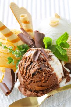 Scoops of ice cream garnished with wafers and chocolate curls
