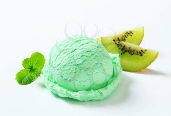 Scoop of light green ice cream and fresh kiwi