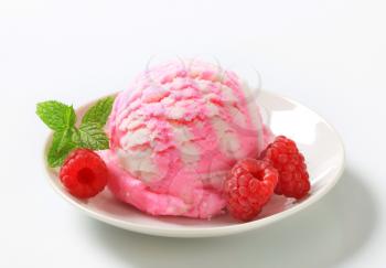 Scoop of ice cream with fresh raspberries