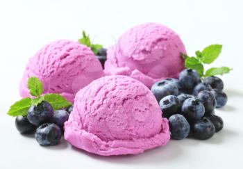 Scoops of blueberry ice cream with fresh berries