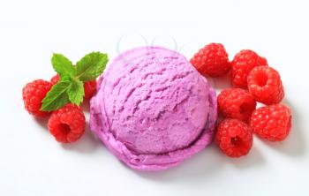Scoop of purple ice cream  and fresh raspberries