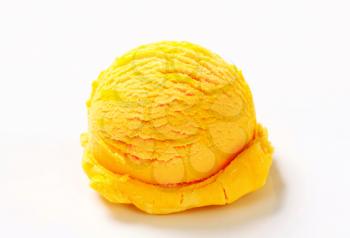 Scoop of yellow ice cream on white background
