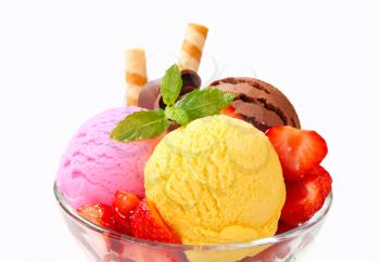 Ice cream sundae with strawberries and wafer sticks