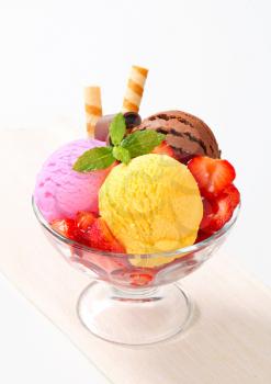Ice cream sundae with strawberries and wafer sticks