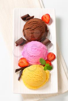 Three scoops of ice cream with different flavors