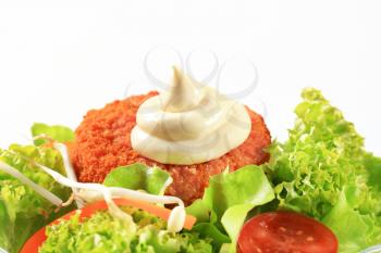 Green salad with fried breaded cheese and mayonnaise