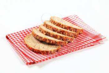 Sliced bread topped with flax and sesame seeds