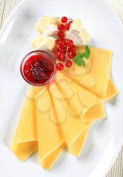 Two kinds of cheese and red currant sauce