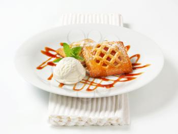 Little apricot pies with ice cream and drizzle sauce