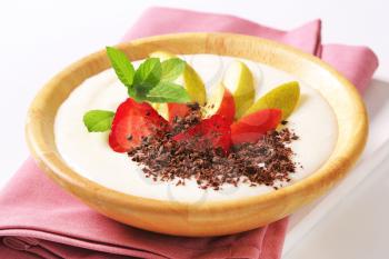 Semolina pudding served with fresh fruit and grated chocolate